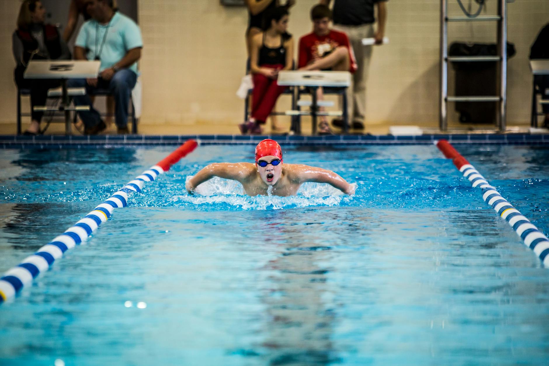 person swimming in pool Webbed Swimming Gloves Benefits
