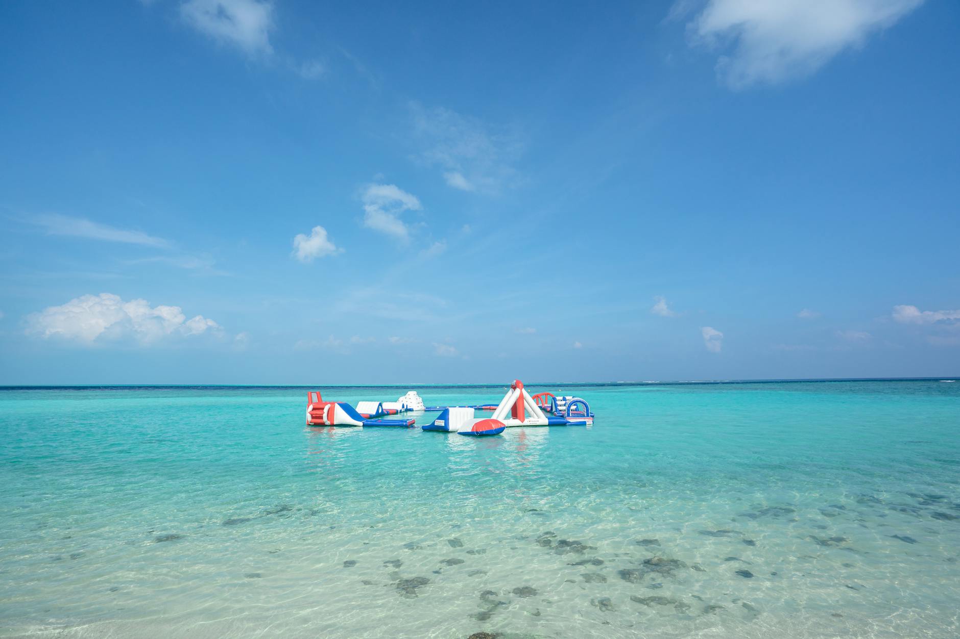 colorful inflatable obstacle course on clear beach pros and cons of using waterproof phone cases in saltwater